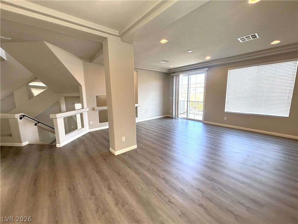 6425 Jackson Spring Road Las Vegas, NV 89118 - Photo 5 of 31 An open living area presents resilient wood-look flooring and abundant natural light from a sliding glass door.