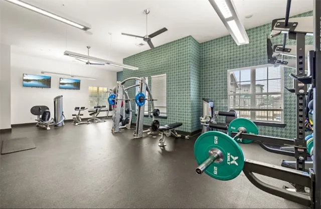 a gym room with gym equipment and a window
