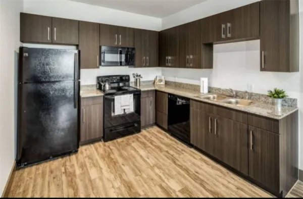 a kitchen with a refrigerator sink and cabinets