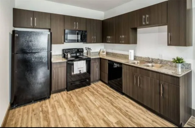 a kitchen with a refrigerator sink and cabinets