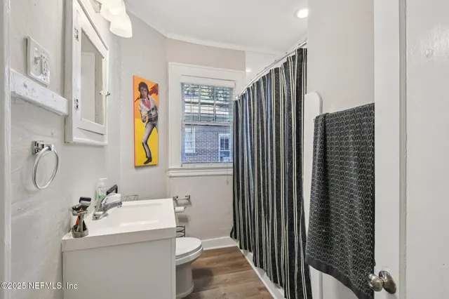 a bathroom with a sink toilet and shower