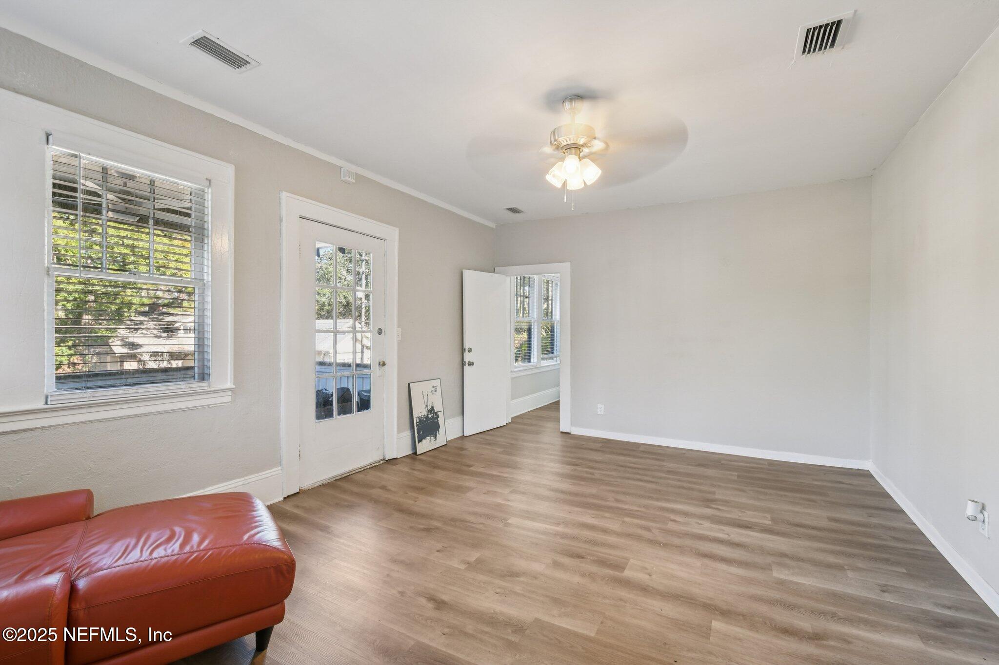 2850 College Street Jacksonville, FL 32205 - Photo 5 of 20 a view of an empty room with wooden floor and a window