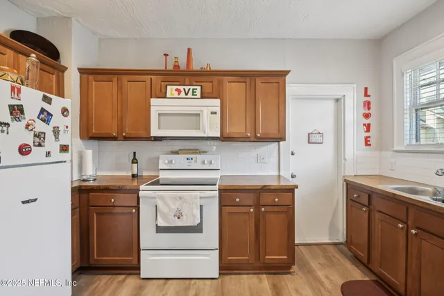 a kitchen with stainless steel appliances granite countertop a sink and a stove