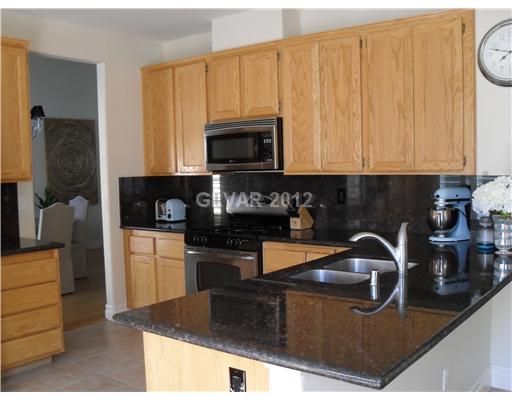 1725 Jack Rabbit Way Las Vegas, NV 89128 - Photo 7 of 17 Kitchen. Breakfast bar, stainless appliances & ample cabinets