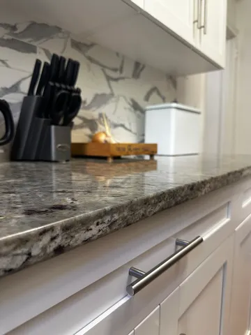 a kitchen with a refrigerator and cabinets