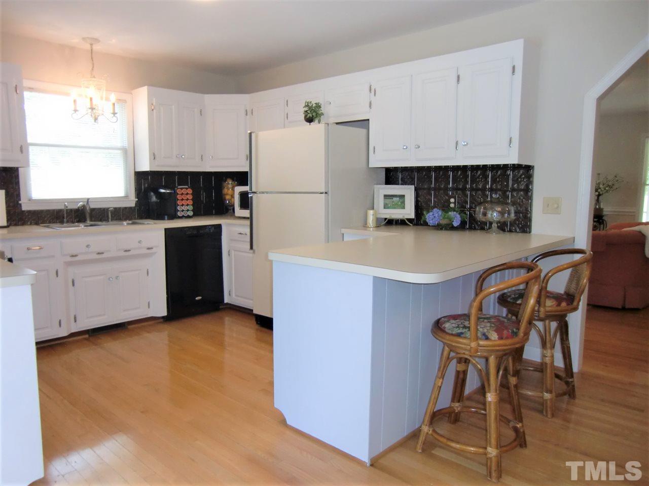 5348 Old Stage Road North Angier, NC 27501 - Photo 10 of 30 Seller is replacing dishwasher with a new stainless steel front, Drawer-Style Dishwasher. There is a filtered tap water dispenser at the sink.