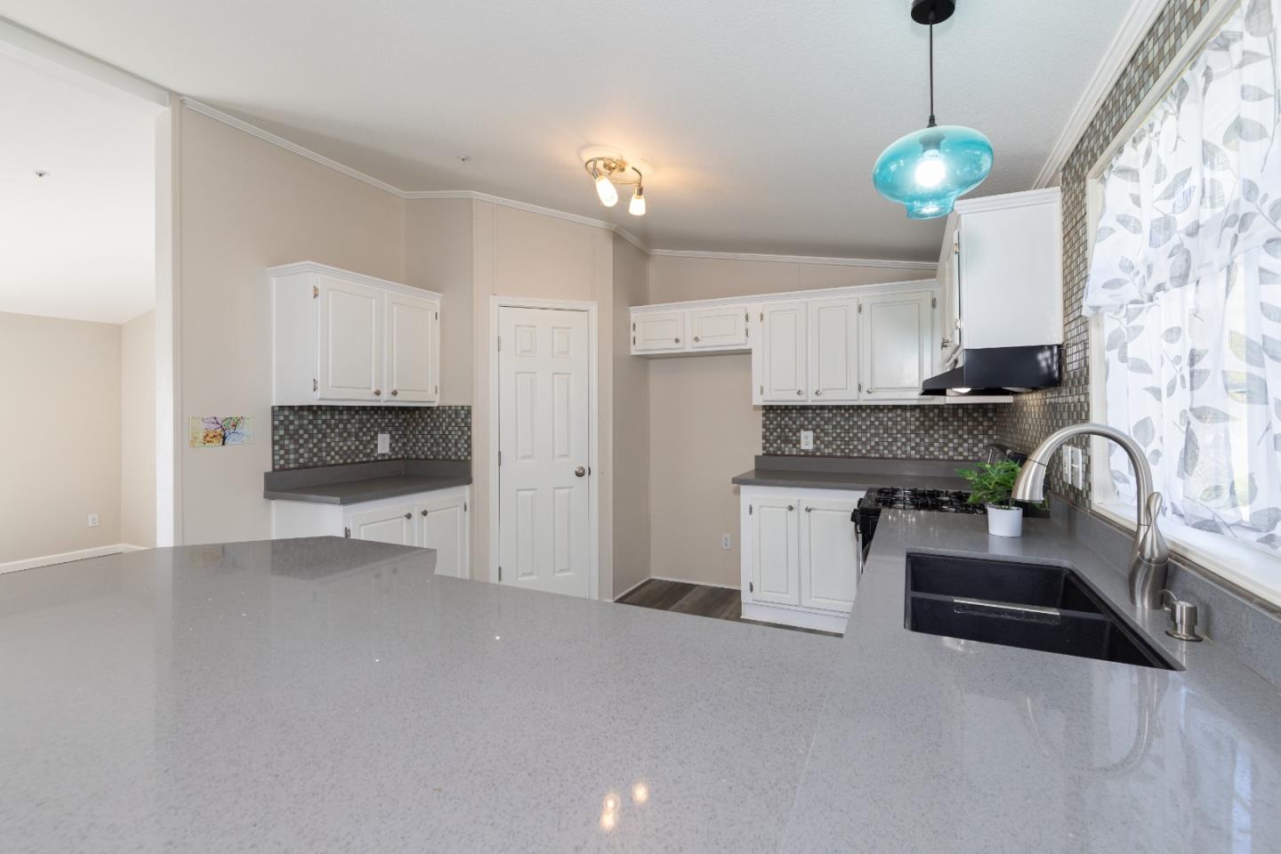 163 Harkins Slough Road Watsonville, CA 95076 - Photo 11 of 21 a kitchen with stainless steel appliances granite countertop a stove and a sink