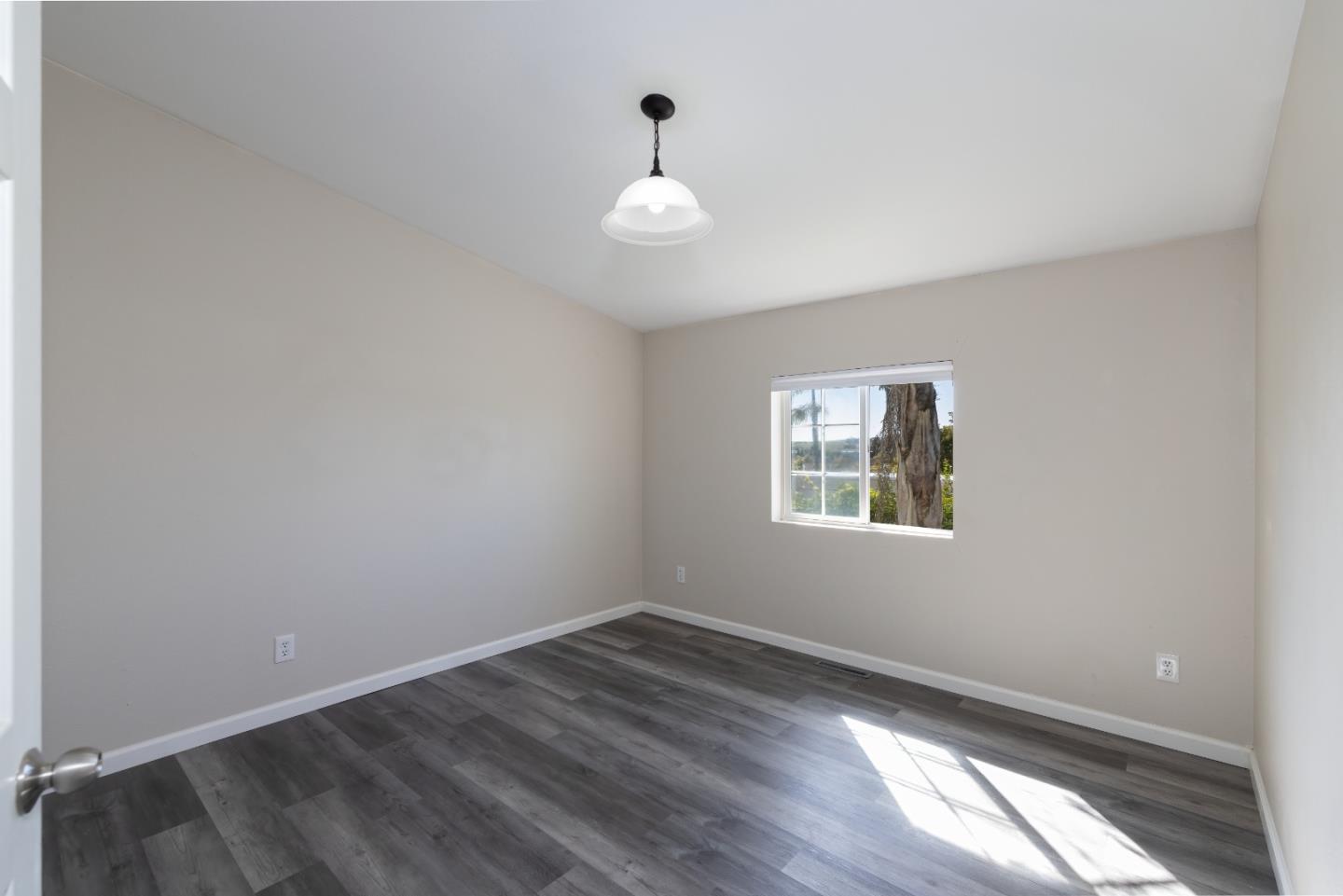 163 Harkins Slough Road Watsonville, CA 95076 - Photo 14 of 21 wooden floor in an empty room with a window