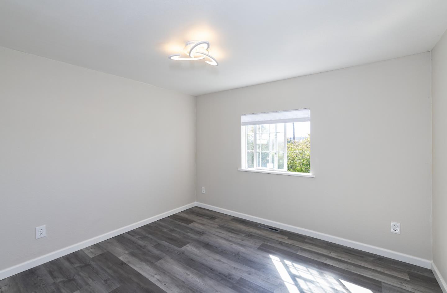 163 Harkins Slough Road Watsonville, CA 95076 - Photo 18 of 21 wooden floor in an empty room with a window