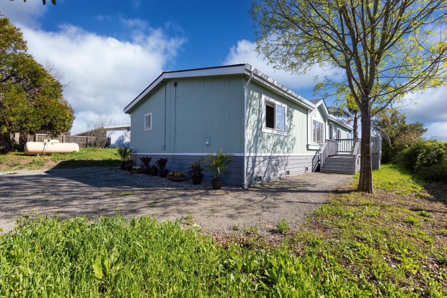 163 Harkins Slough Road Watsonville, CA 95076 - Photo 21 of 21 a backyard of a house with a garden and plants