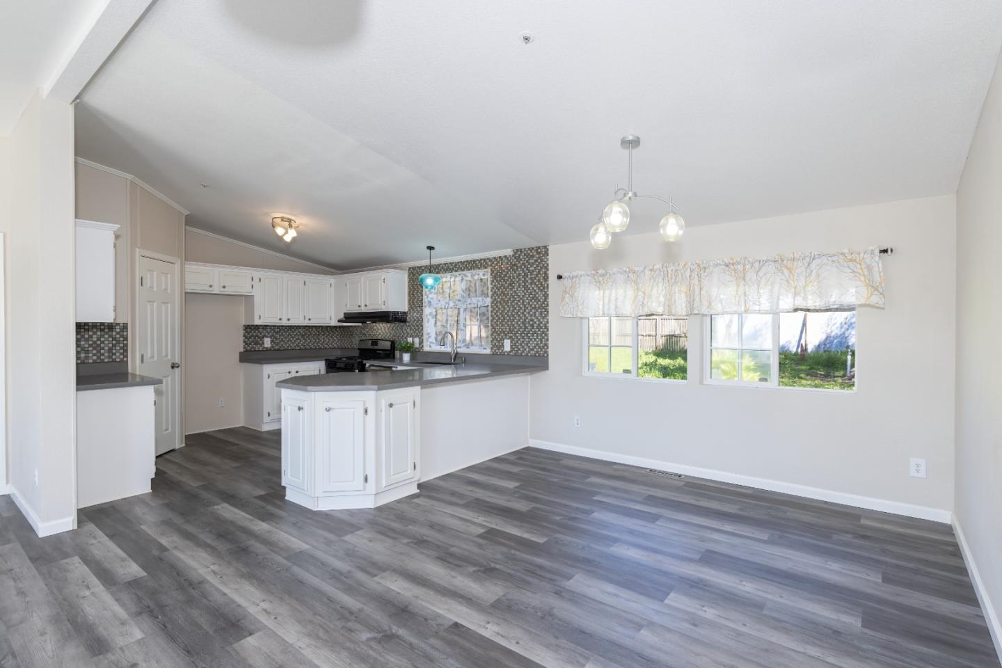 163 Harkins Slough Road Watsonville, CA 95076 - Photo 4 of 21 a kitchen with stainless steel appliances a refrigerator sink and white cabinets