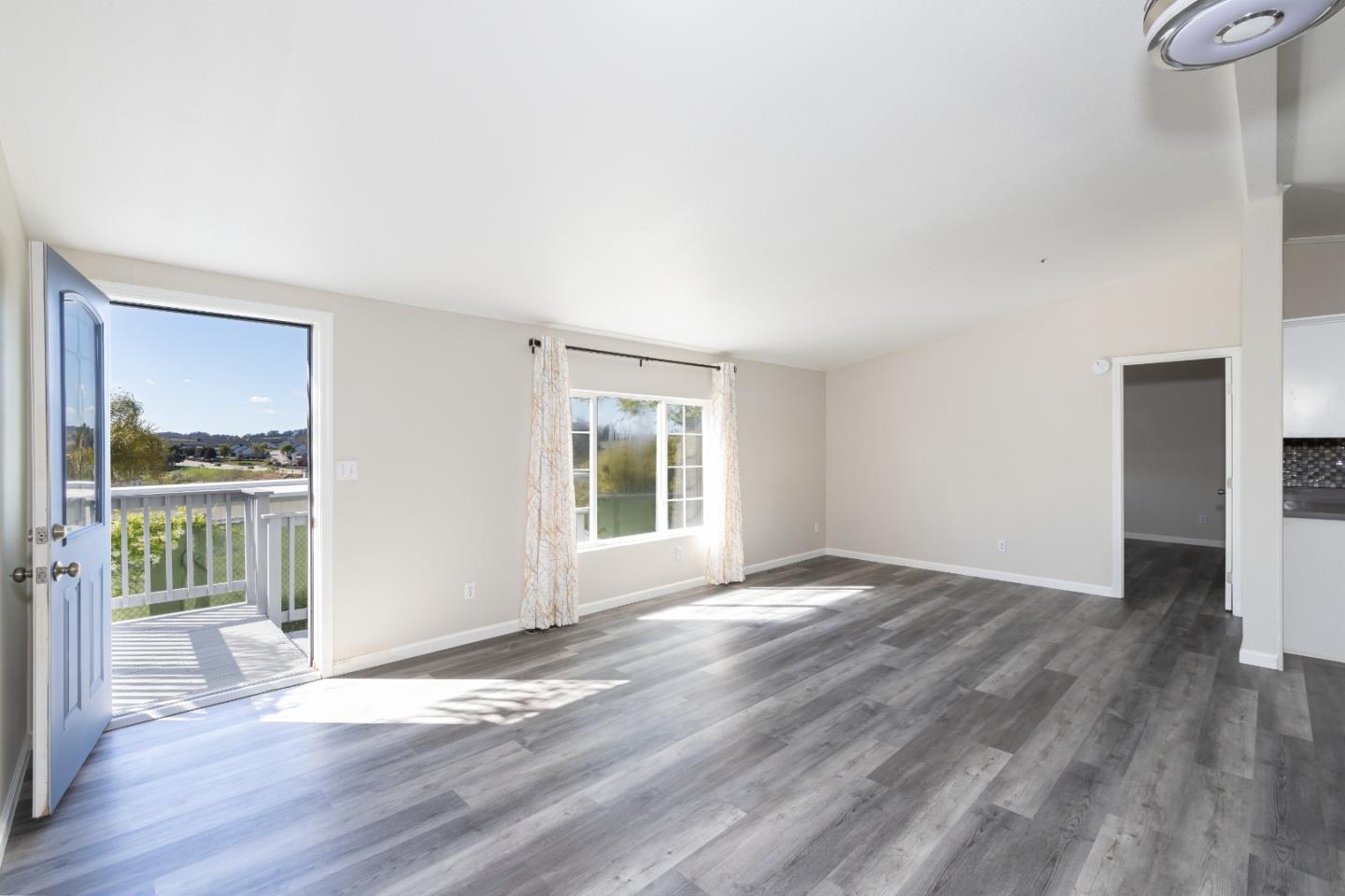 163 Harkins Slough Road Watsonville, CA 95076 - Photo 5 of 21 a view of an empty room with a window and wooden floor
