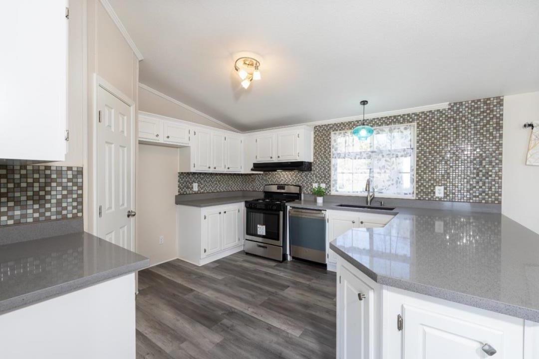 163 Harkins Slough Road Watsonville, CA 95076 - Photo 7 of 21 a kitchen with granite countertop stainless steel appliances and wooden cabinets