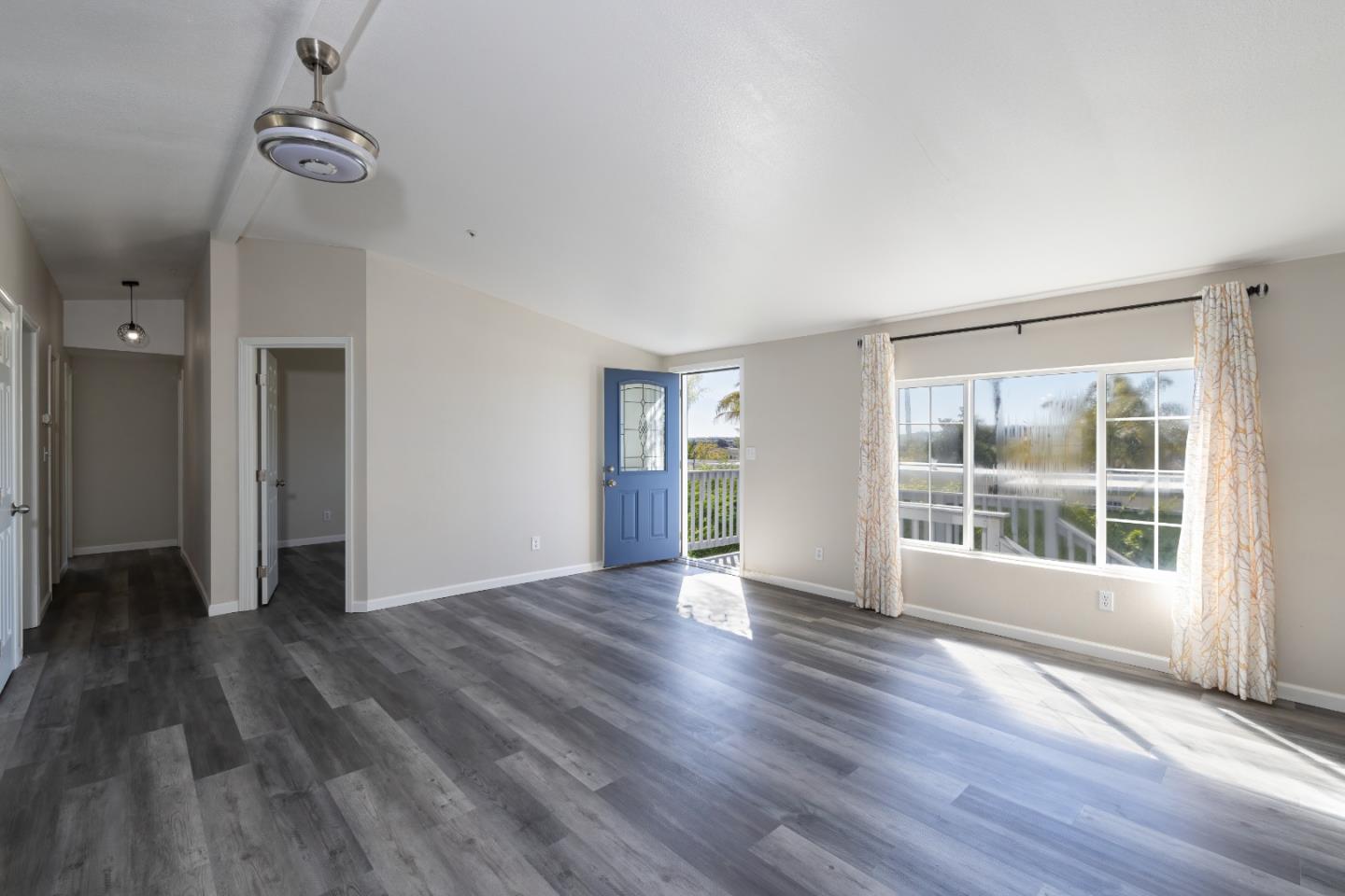 163 Harkins Slough Road Watsonville, CA 95076 - Photo 8 of 21 a view of an empty room with wooden floor and a window