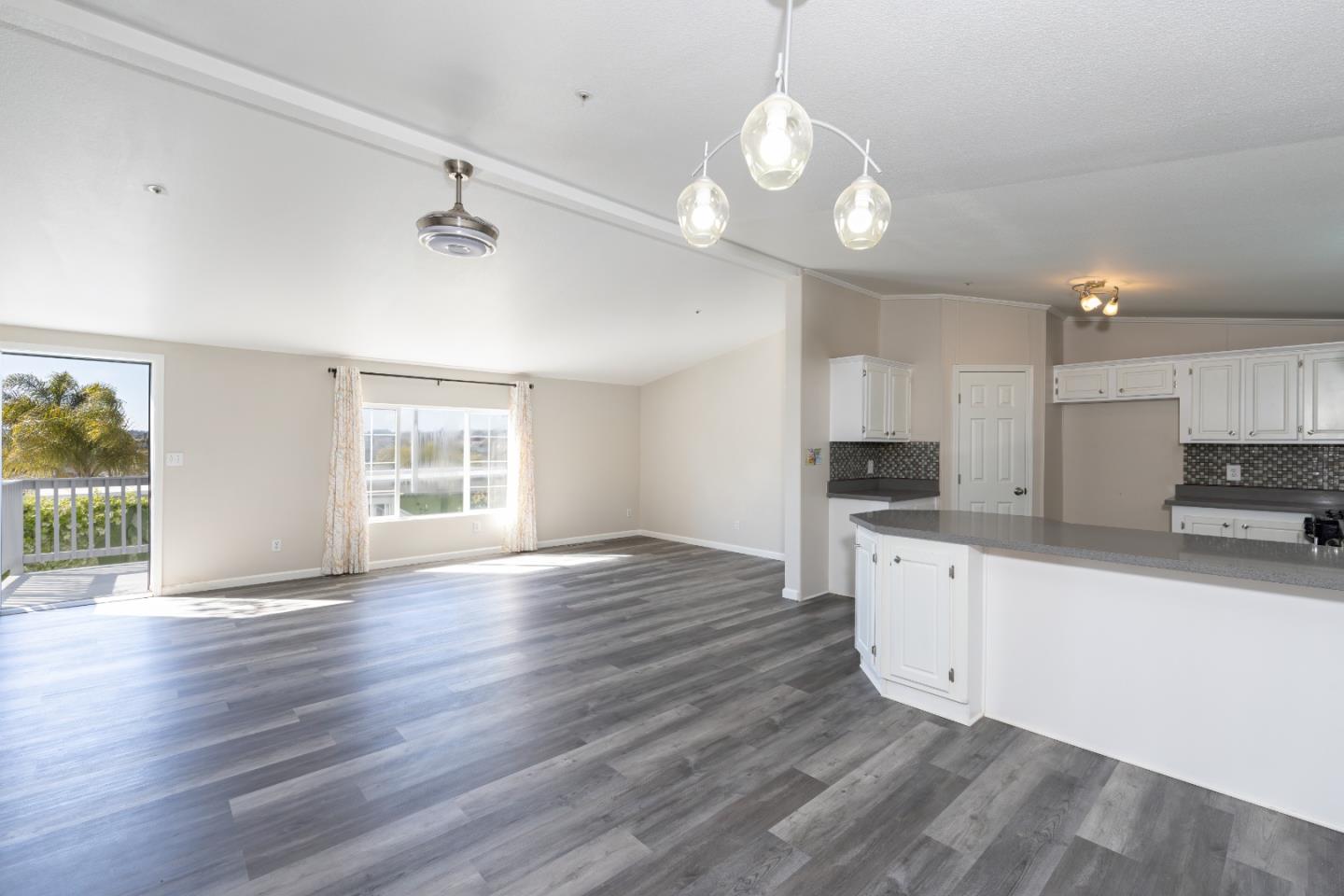 163 Harkins Slough Road Watsonville, CA 95076 - Photo 10 of 21 a large kitchen with hardwood floor a large window and stainless steel appliances