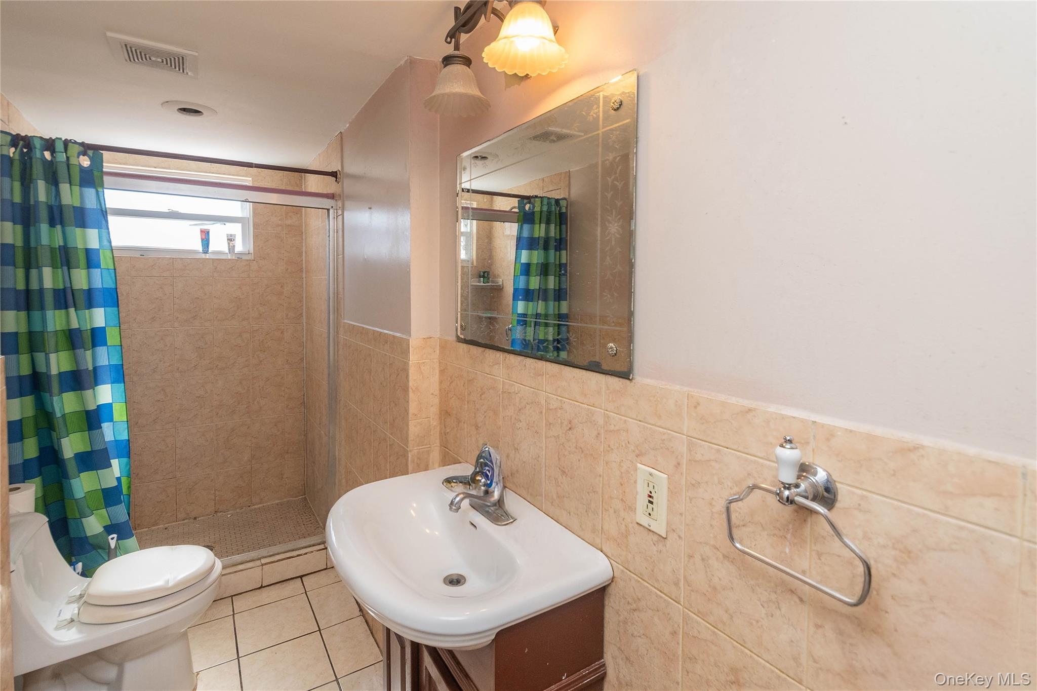 7 Merrick Lane Spring Valley, NY 10977 - Photo 15 of 28 a bathroom with a sink mirror and toilet