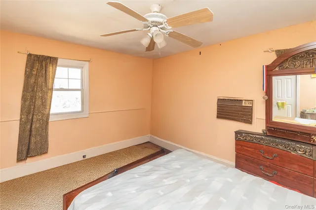 a view of a room with a ceiling fan and a window