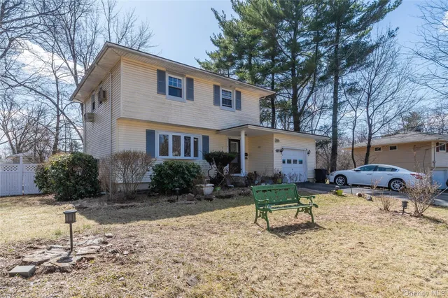 a view of backyard of house with outdoor seating and barbeque oven