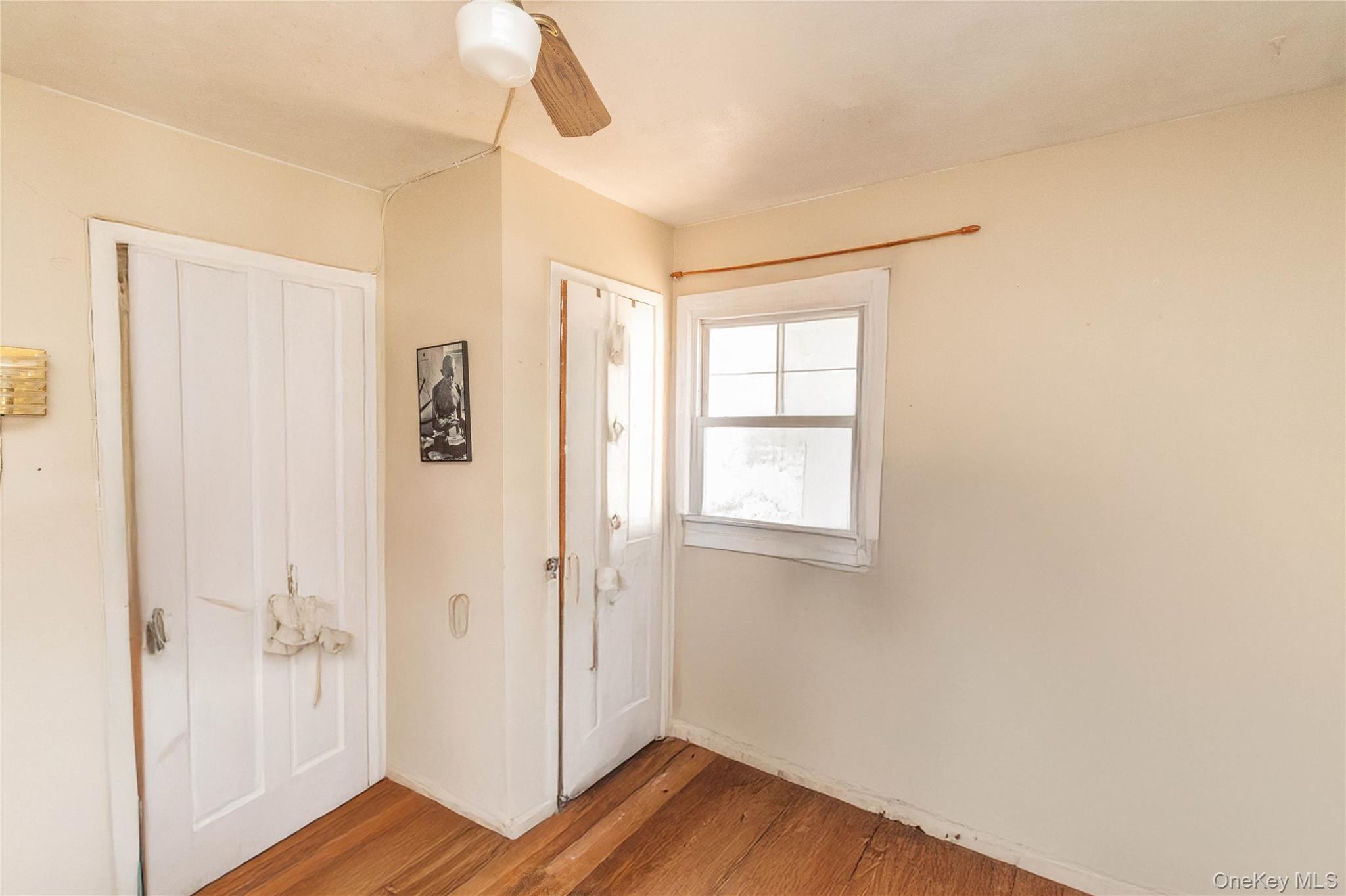 7 Merrick Lane Spring Valley, NY 10977 - Photo 21 of 28 a view of an empty room with wooden floor and a window
