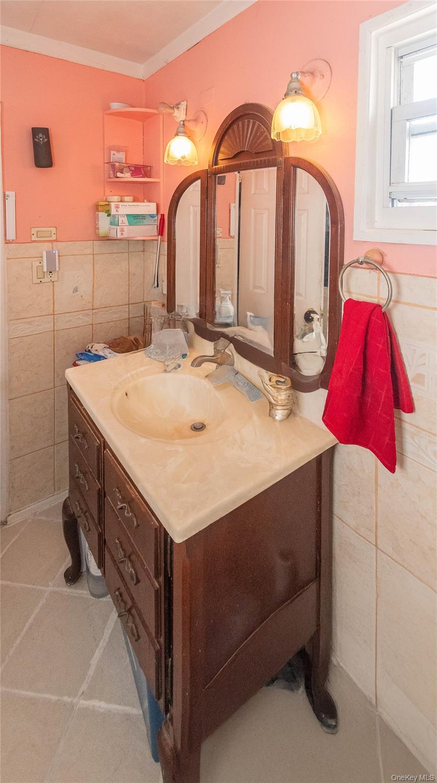 7 Merrick Lane Spring Valley, NY 10977 - Photo 22 of 28 a bathroom with a sink and a mirror