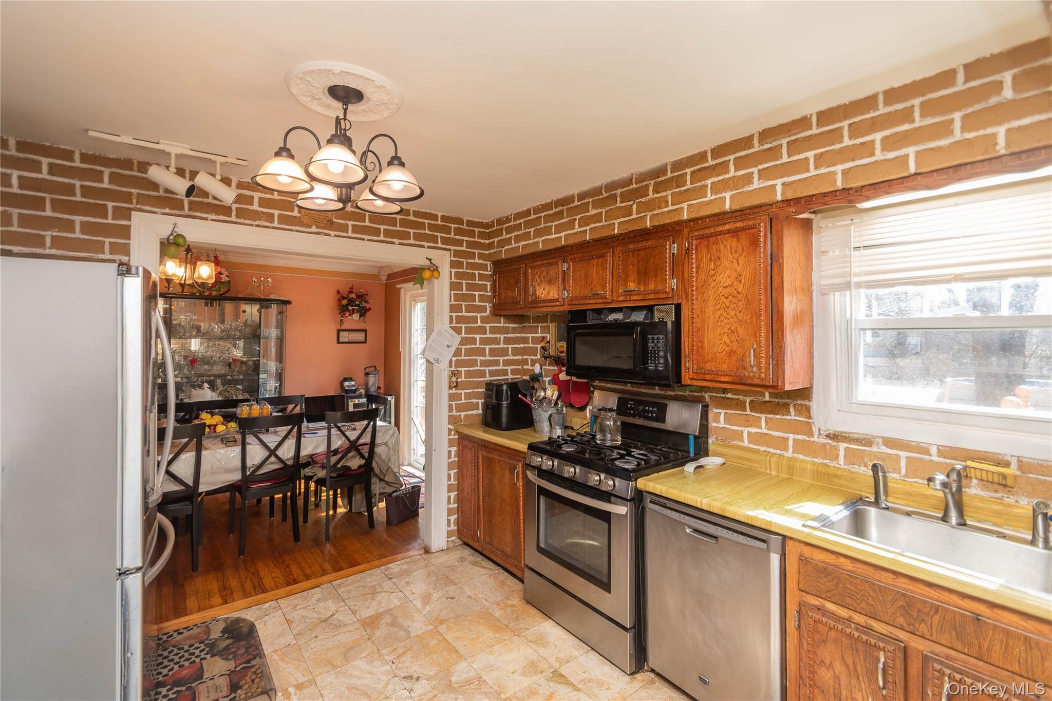 7 Merrick Lane Spring Valley, NY 10977 - Photo 7 of 28 a kitchen with a sink a stove and chairs