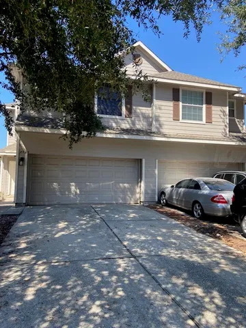 a view of a car parked front of a house