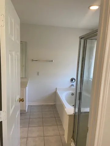 a bathroom with a tub and shower