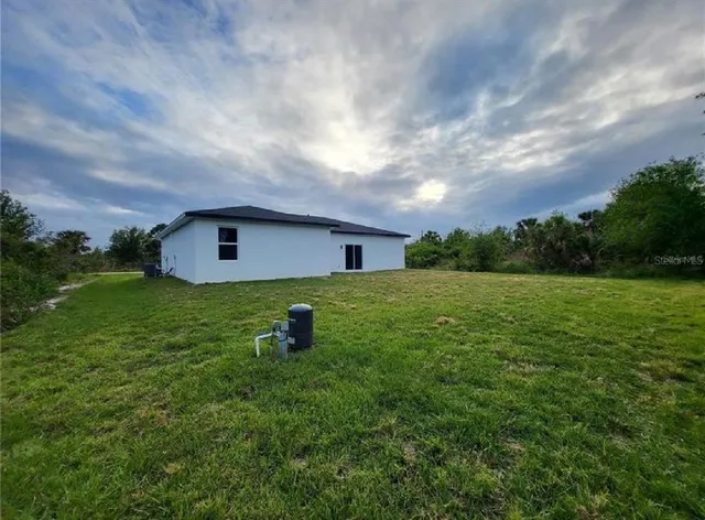 a view of an house with backyard space and garden