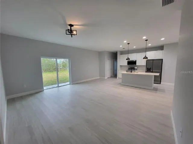 a view of a kitchen with a sink and a refrigerator
