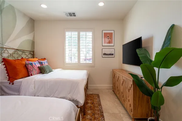 a bedroom with a bed a lamp and a table