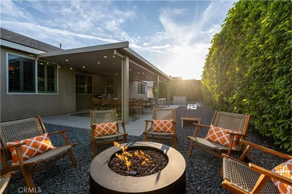 a view of a patio with table and chairs and potted plants