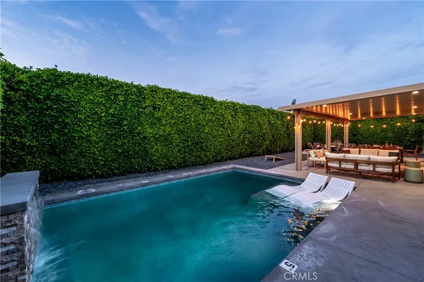 a view of a backyard with a table and chairs