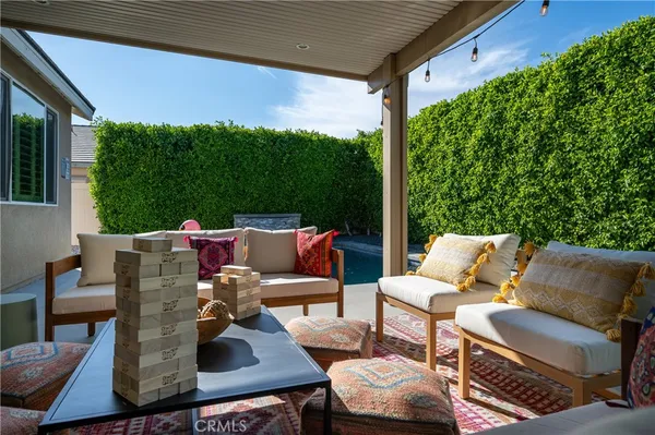 a view of a deck with couches table and chairs with wooden floor