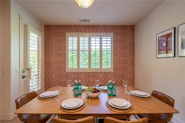 a table and chairs in a dining room with a table