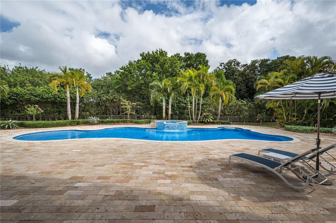 5780 Southwest 128th Avenue Southwest Ranches, FL 33330 - Photo 20 of 80 a view of a swimming pool with an outdoor space and seating area