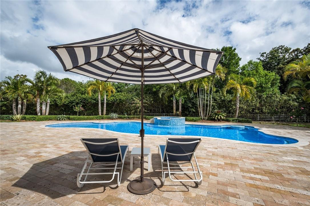 5780 Southwest 128th Avenue Southwest Ranches, FL 33330 - Photo 22 of 80 a view of a swimming pool with chair and table