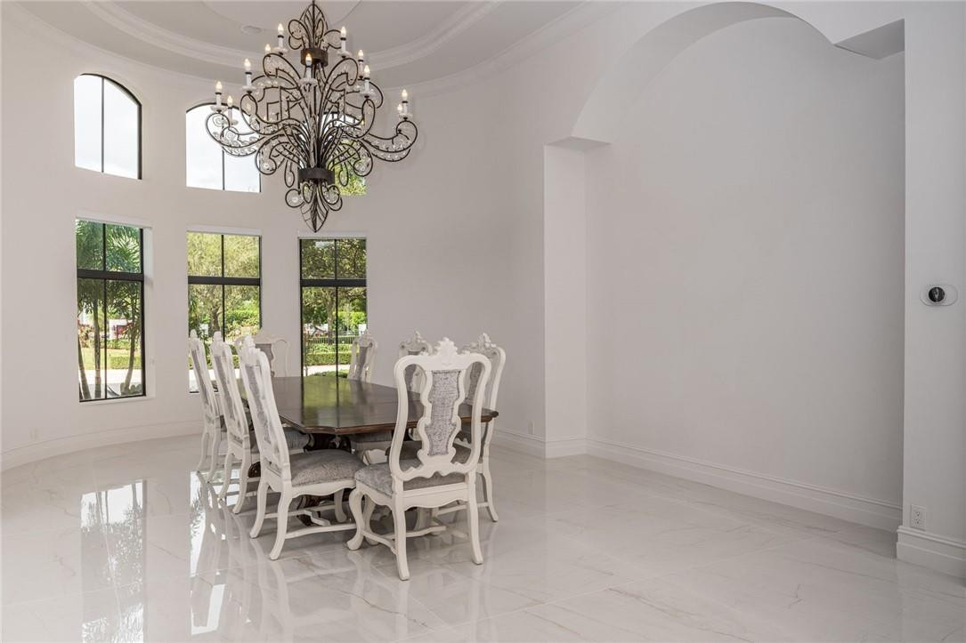 5780 Southwest 128th Avenue Southwest Ranches, FL 33330 - Photo 37 of 80 a view of a dining room with furniture a chandelier and window