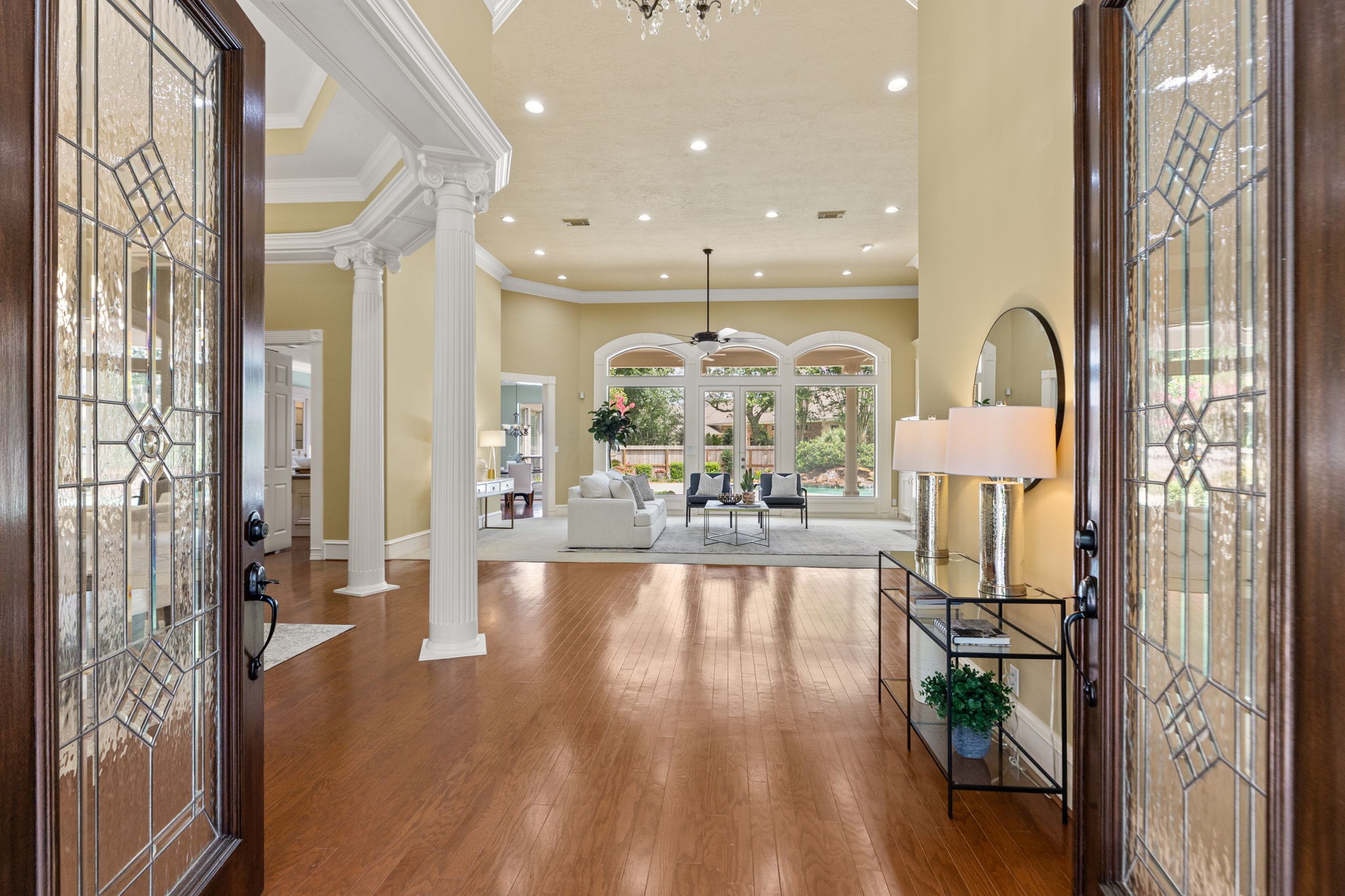 6610 Radley Drive Spring, TX 77379 - Photo 5 of 50 Lead glass french doors welcome you to this custom designed home. First impression... wow! Full view to back yard oasis. Notice beautiful wood flooring, columns & window transoms.