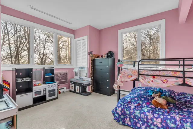 a bedroom with furniture and a large window