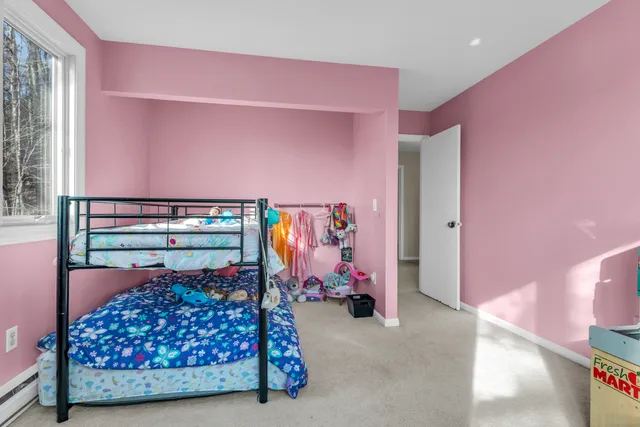 a bedroom with bed and a window