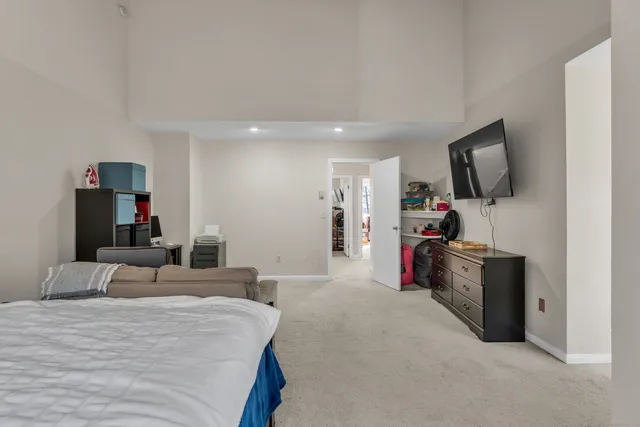 a bed room with a bed and a television