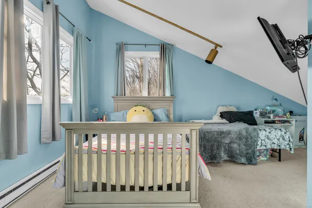 a bedroom with a bed and window