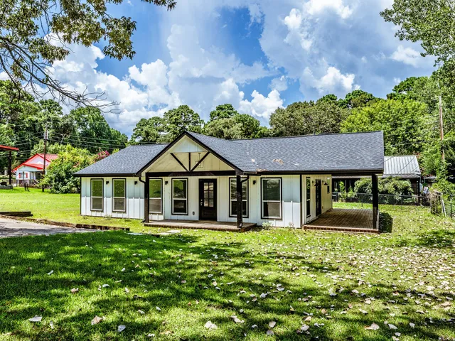 a front view of a house with a yard table and chairs