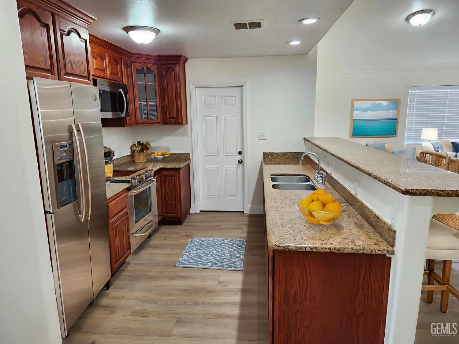 Undisclosed Address Delano, CA 93215 - Photo 11 of 33 a kitchen with stainless steel appliances granite countertop a refrigerator a stove and a sink