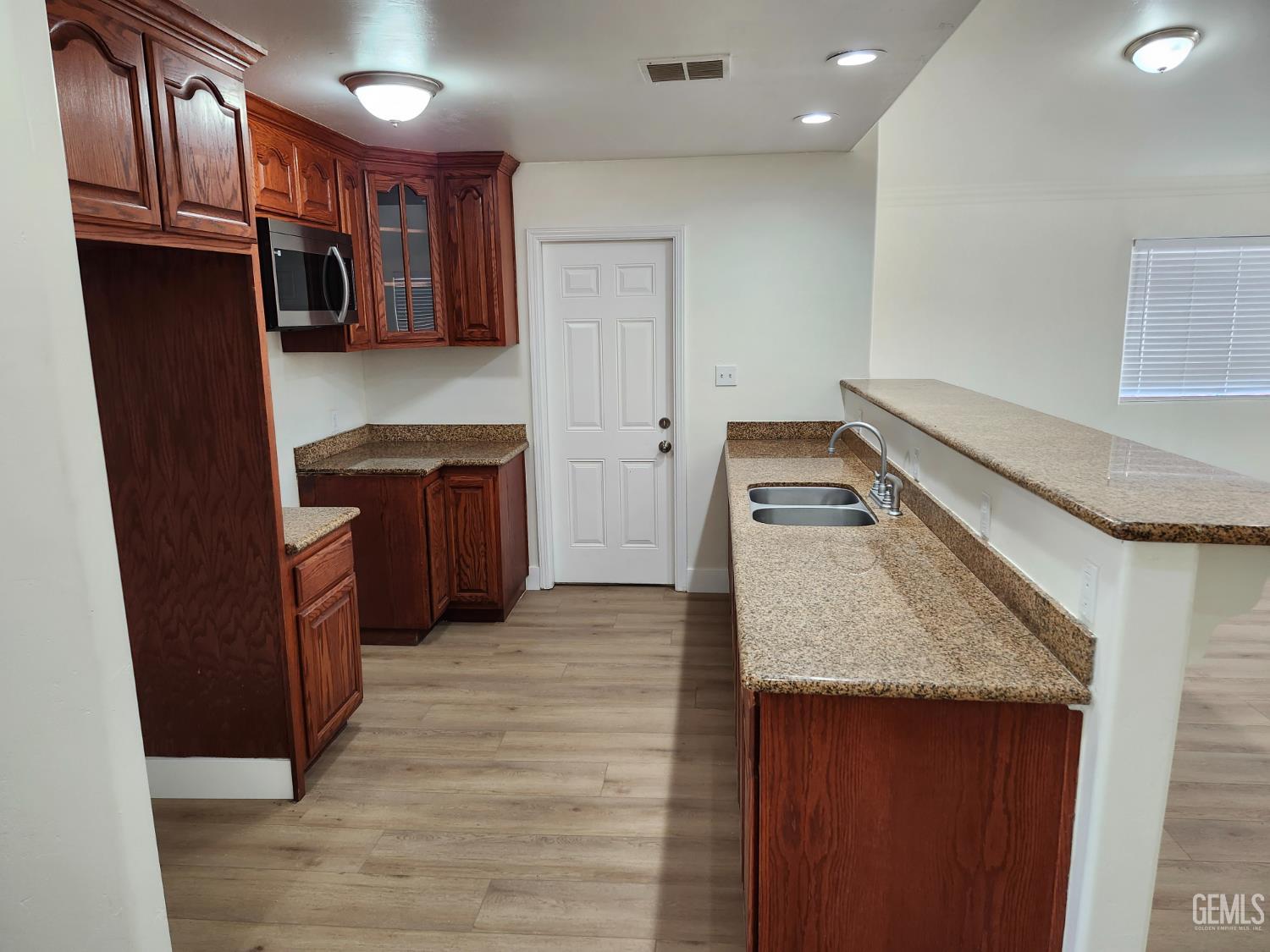 Undisclosed Address Delano, CA 93215 - Photo 12 of 33 a kitchen with a refrigerator stove and cabinets