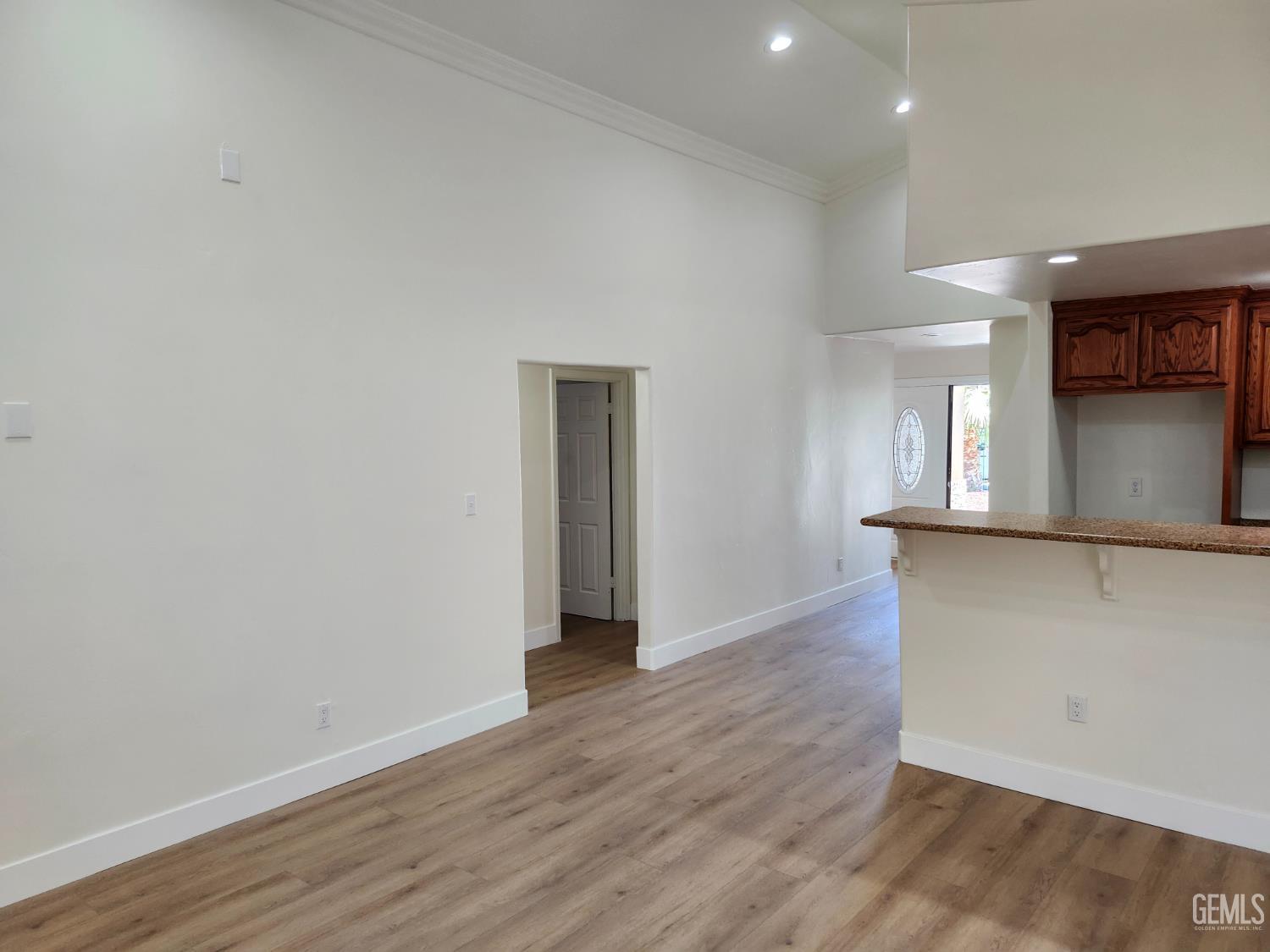 Undisclosed Address Delano, CA 93215 - Photo 15 of 33 a view of a kitchen with wooden floor and a window