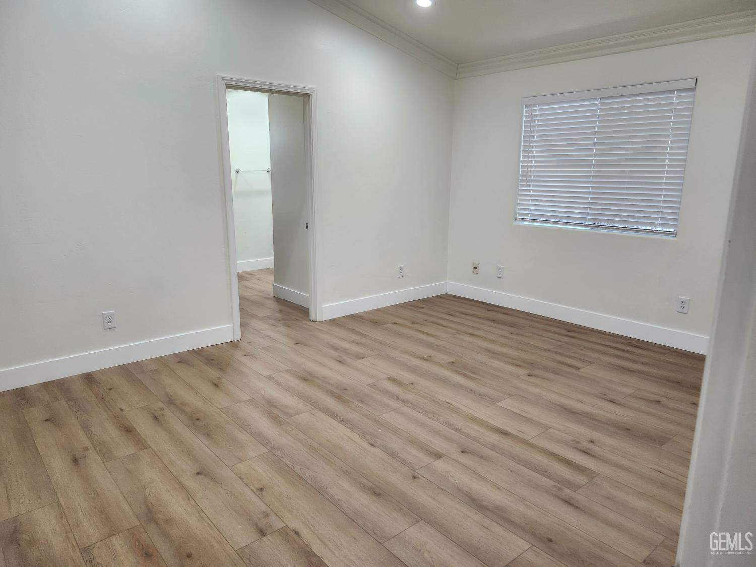 Undisclosed Address Delano, CA 93215 - Photo 17 of 33 a view of an empty room with wooden floor and a window