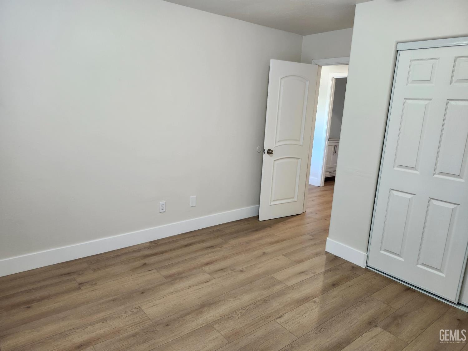 Undisclosed Address Delano, CA 93215 - Photo 26 of 33 an empty room with wooden floor and entrance