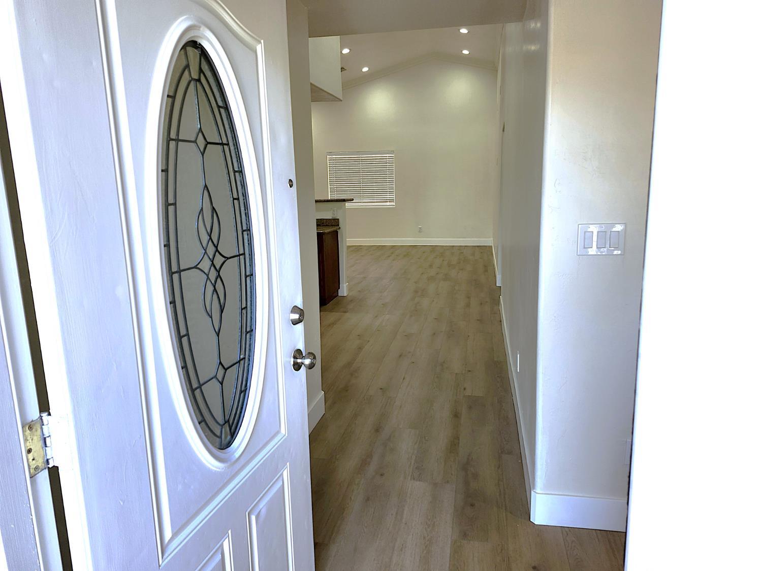 Undisclosed Address Delano, CA 93215 - Photo 3 of 33 a view of a hallway with wooden floor