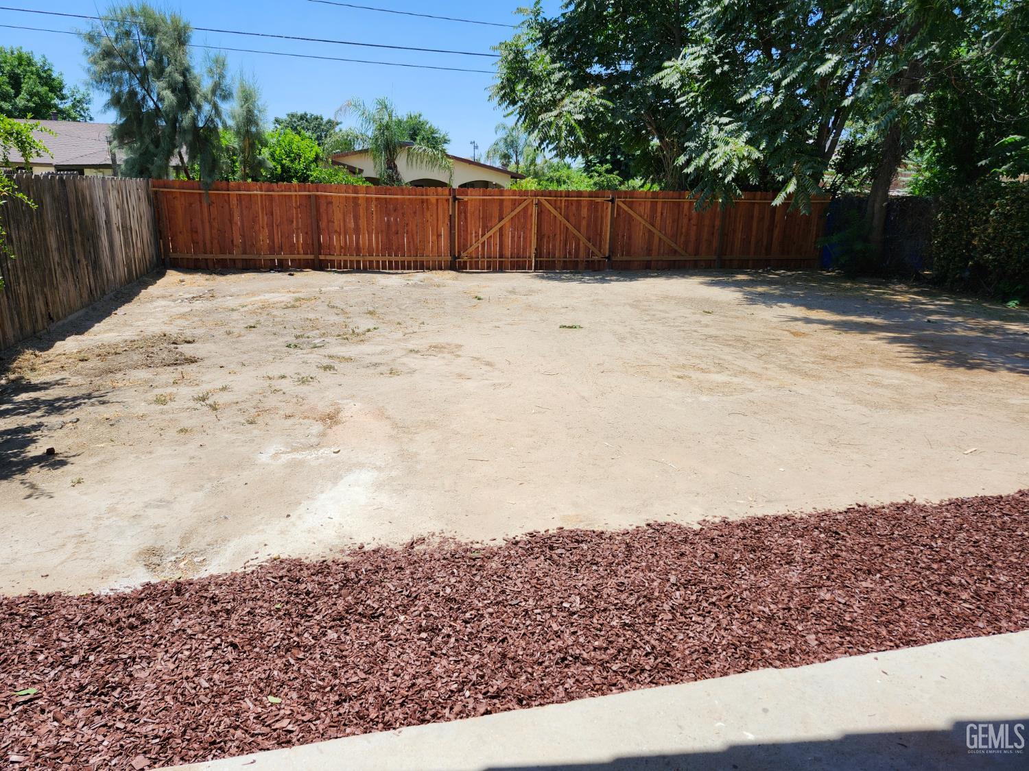 Undisclosed Address Delano, CA 93215 - Photo 31 of 33 a street view with wooden fence